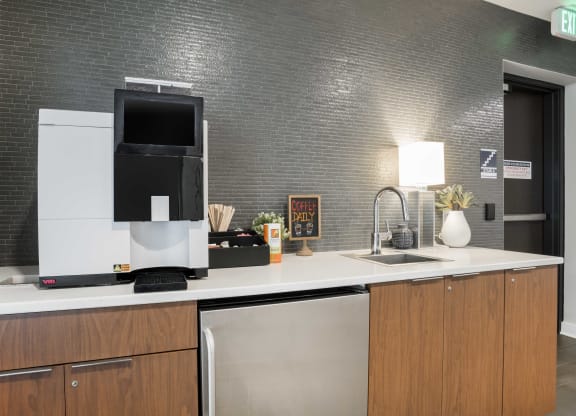 a kitchen with a coffee maker and a sink