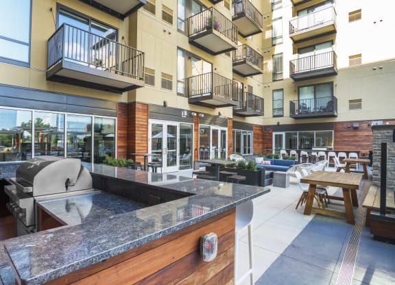 a kitchen with a counter and a grill in front of an apartment building