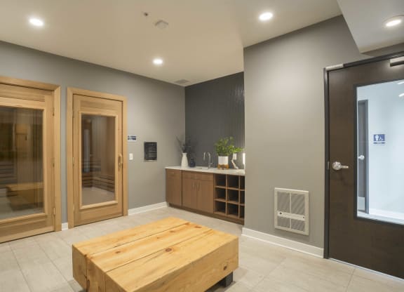 a large room with a wooden table in the center and two doors