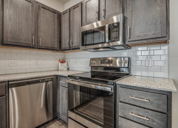 Kitchen with Dark Brown Cabinetry and Stainless Steel Appliances