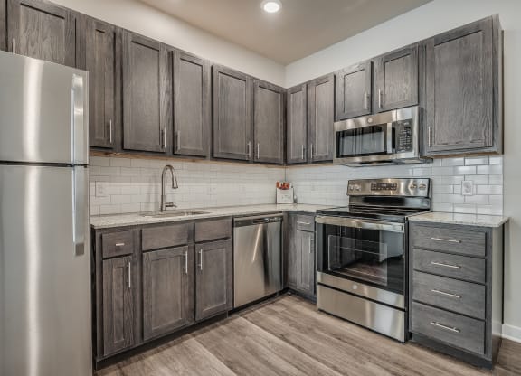 Kitchen with Dark Brown Cabinetry and Stainless Steel Appliances