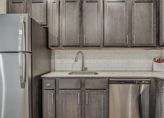 Kitchen with Dark Brown Cabinetry and Stainless Steel Appliances