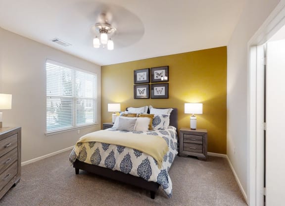 Spacious Bedroom with Large Double Windows and Ceiling Fan with Light