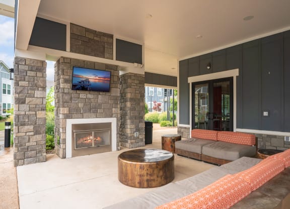 Outdoor Lounge with Mounted TV and Fireplace