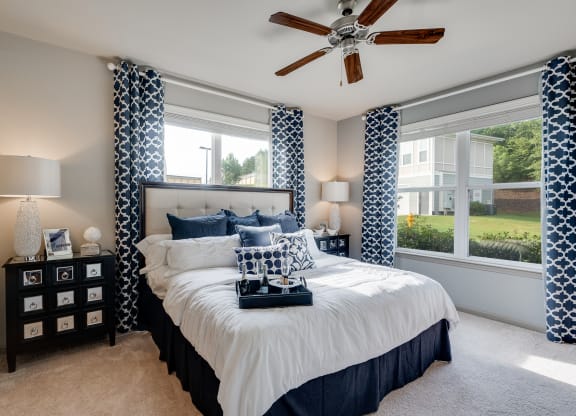 Bedroom With Multiple Windows That Let In Lots Of Natural Light