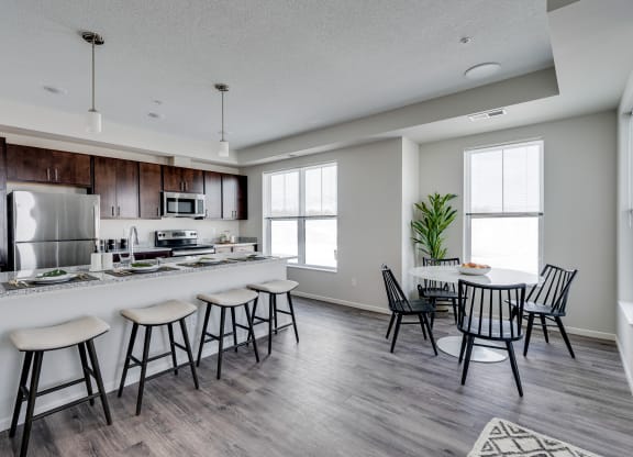Expansive Granite Kitchen Island With Four Bar Stool Seats