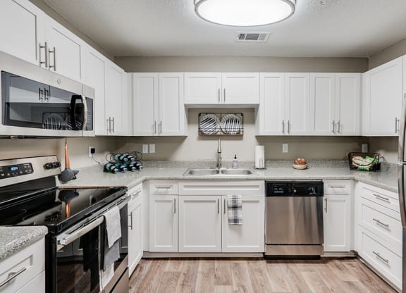 White Cabinetry with Stainless Steel Appliances