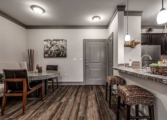 A kitchen with a bar area and a dining table.