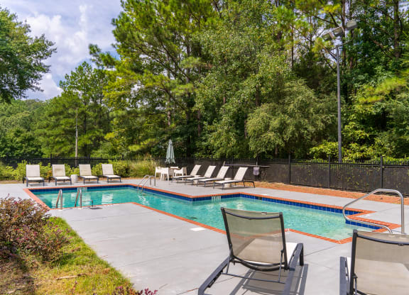 Pool & Sundeck Surrounded By Lush Trees & Landscaping