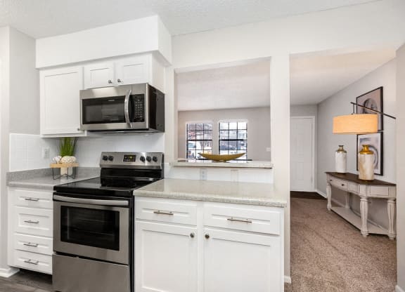 Renovated Kitchen with White Tile Backsplash and Stainless Steel Appliances