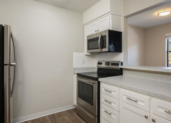 Kitchen With Brushed Nickel Hardware & White Cabinetry