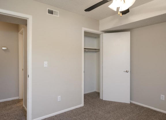 Bedroom With Plush Carpeting & Ceiling Fan With Light