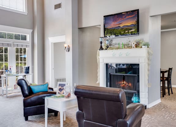 Clubhouse Lounge Area with Mounted TV and Fireplace