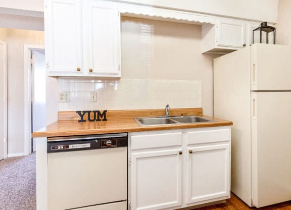Classic Kitchen with White Cabinets and Almond Colored Appliances