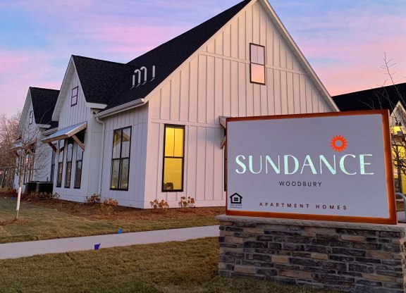 Exterior of the Clubhouse with Monument Sign at Dusk