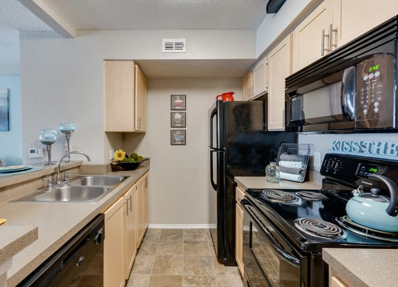 Kitchen with Tiled Flooring and Black Appliances