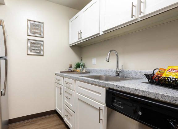 Kitchen with White Cabinets, Stainless Steel appliances and Hardware