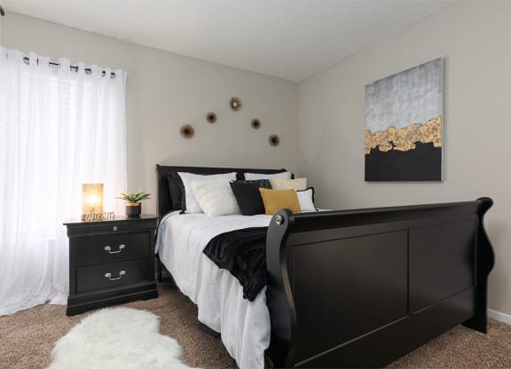 Bedroom with Plush Carpet and Large Window with Built-In Blinds