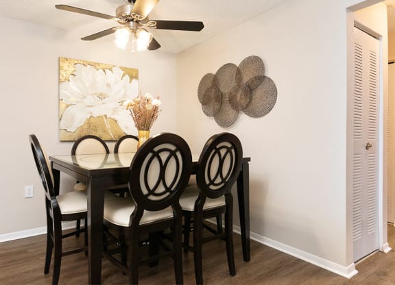 Spacious Dining Room with Ceiling Fan and Light and Hardwood Style Flooring