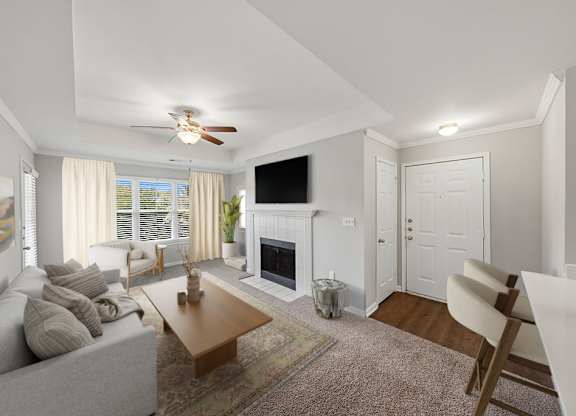 Spacious living area with fireplace and large windows.