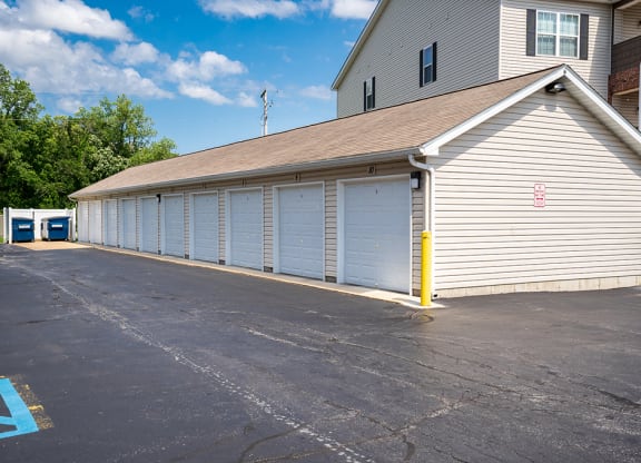 a garage with white doors and a parking lot