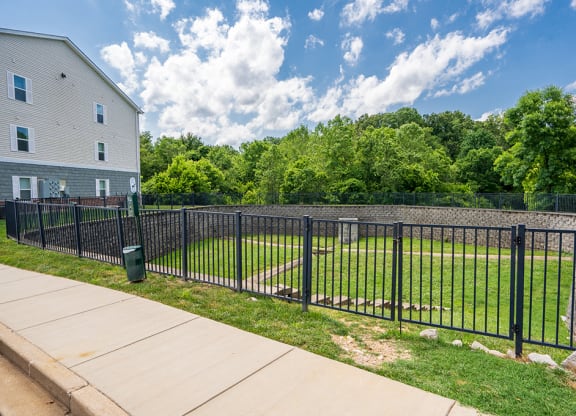 the yard is fenced off with a black metal fence