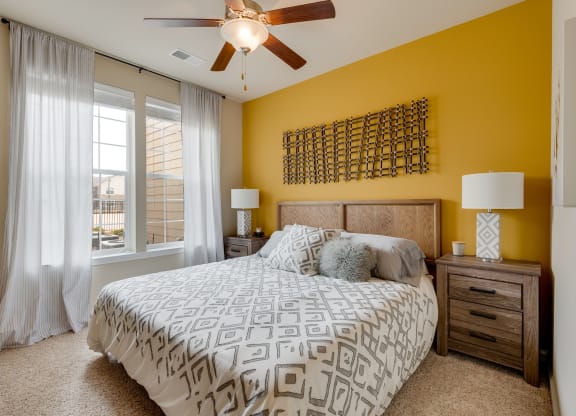 Bedroom With Plush Carpet & Large Windows