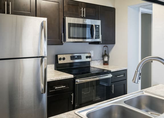 Fully-Equipped Modern Kitchen with Stainless Steel Appliances with Granite Countertops