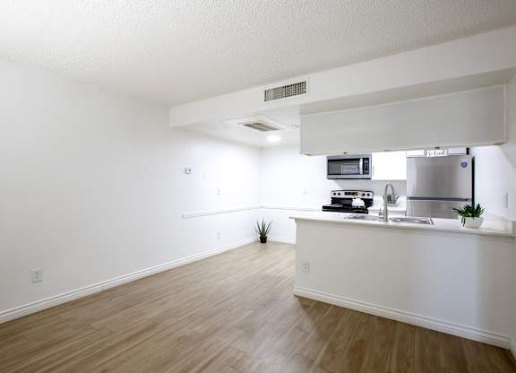 A kitchen area with a counter and a microwave.