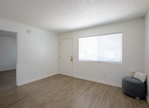 A room with a window and a door.