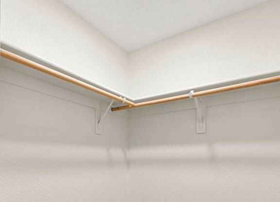 A white wall with a grey carpet and a white ceiling with a light on.