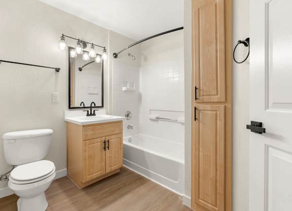 A white toilet sits next to a sink in a bathroom.