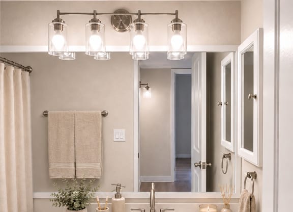 A white bathroom with a towel hanging on the wall.