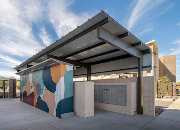 A modern building with a colorful mural on the side.