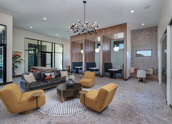 A modern living room with a sofa, chairs, and a coffee table.