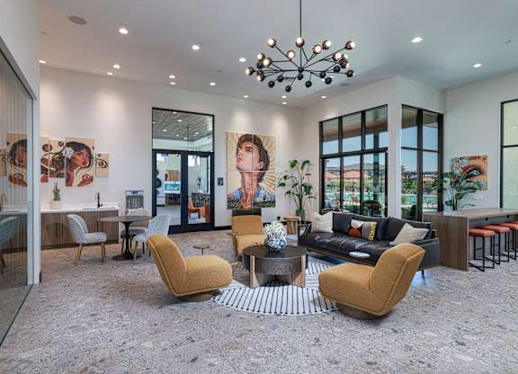 A modern living room with a yellow chair in the center.