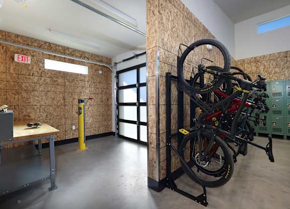 A room with a bicycle rack and a table.