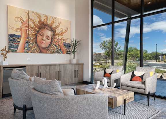 A living room with a large painting of a woman with sun in her hair.
