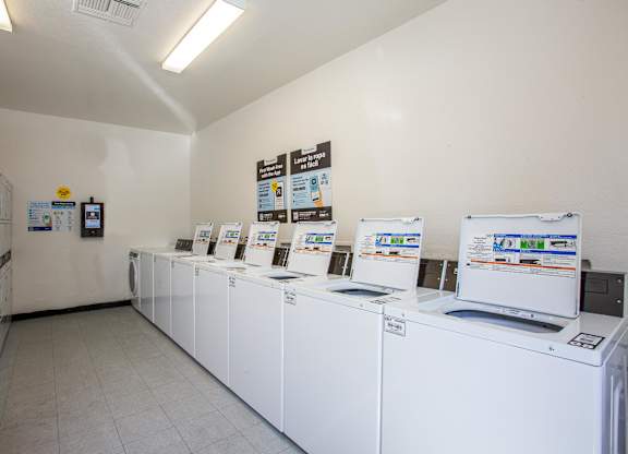 A laundromat with rows of washers and dryers.