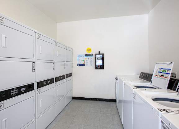 A row of washing machines in a laundromat.