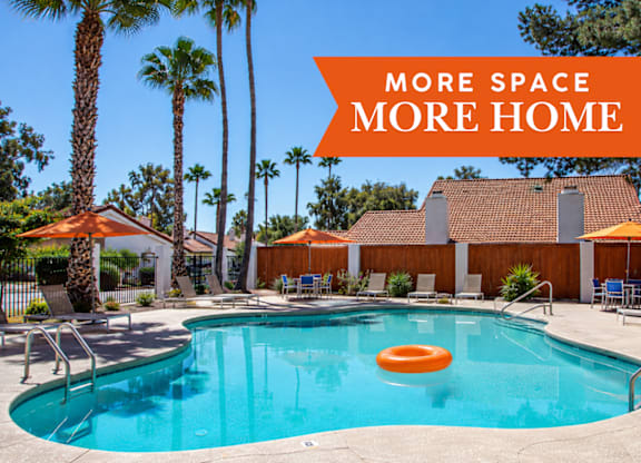 A pool surrounded by palm trees and a sign that says "More Space More Home".