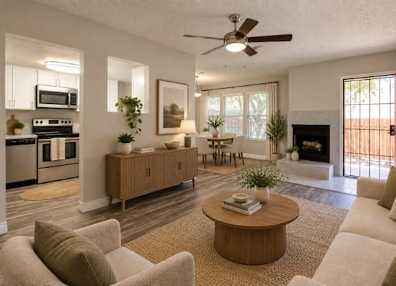 A living room with a fireplace and a dining table.