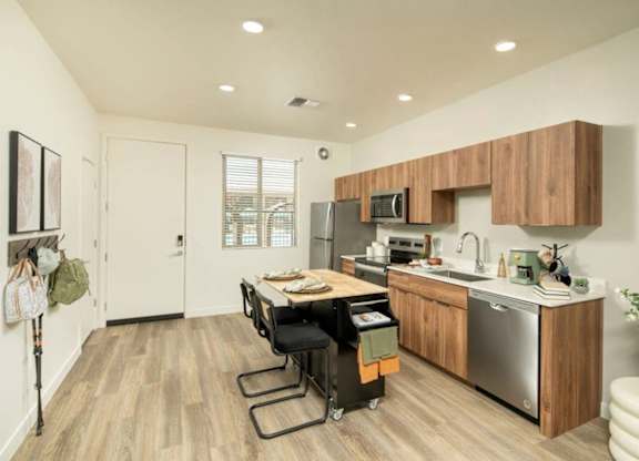 A kitchen with a wooden counter and stainless steel appliances.