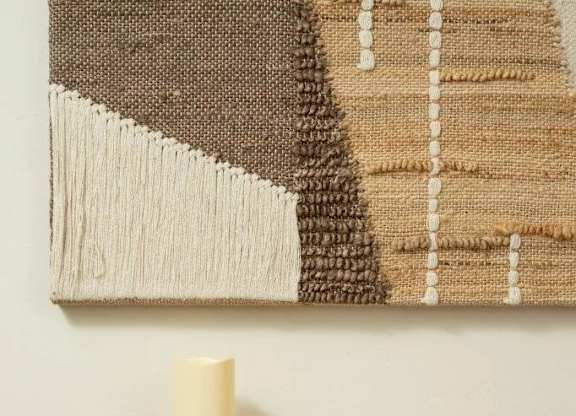 Three candles are lit and placed on a dresser.