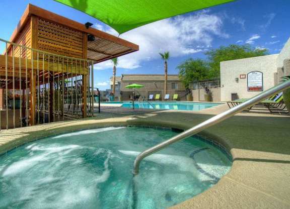A hot tub sits in the middle of a pool area.