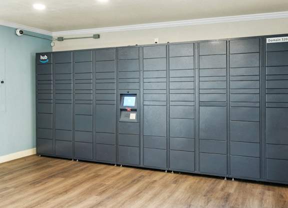 A row of lockers in a room with a wooden floor.