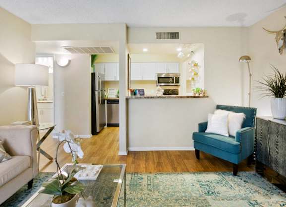 A living room with a blue couch and a coffee table.