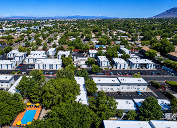 A bird's eye view of a residential area with a swimming pool.