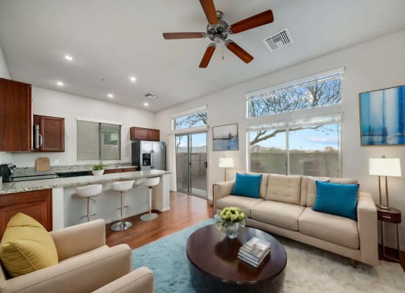 Spacious Living Room and Kitchen with Breakfast Bar at Avilla Preserve Apartment Homes in Tucson Arizona