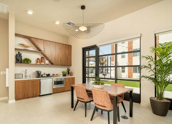 A modern kitchen with a dining table and chairs.
